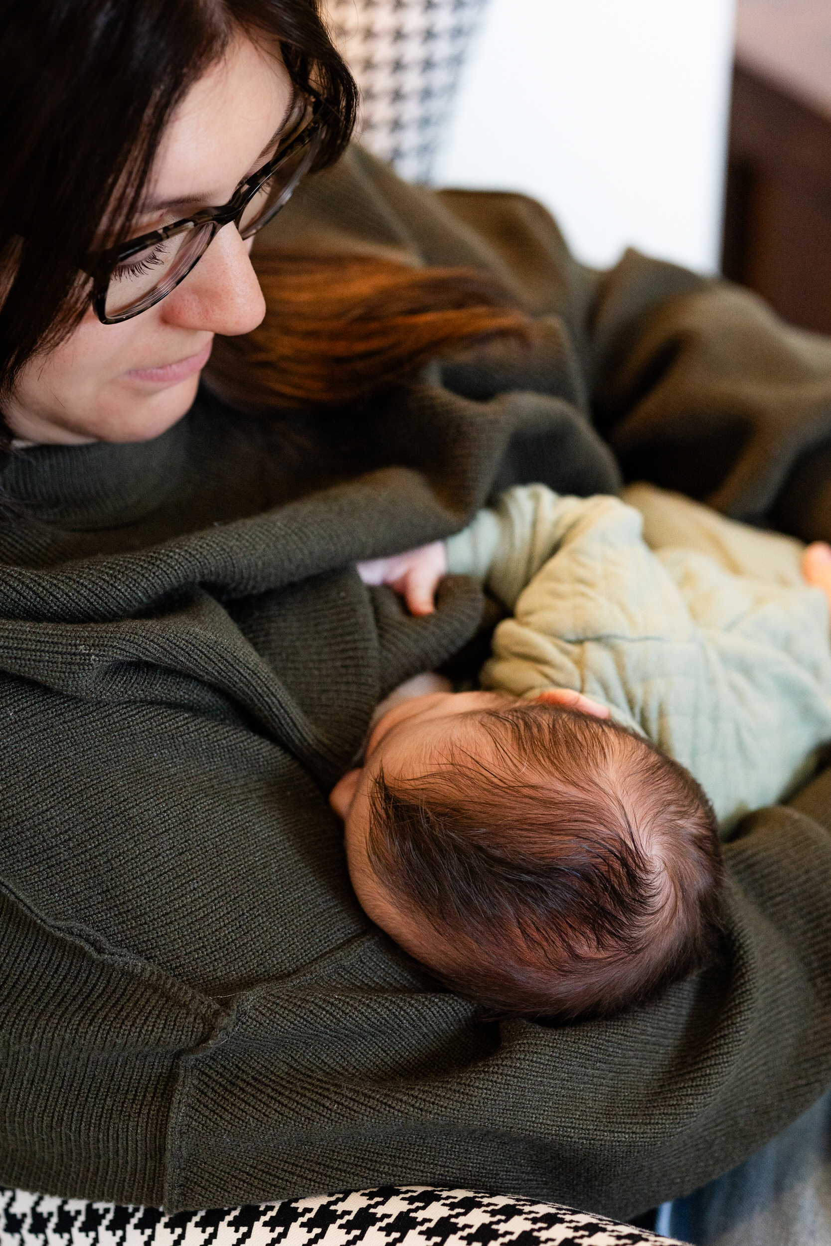 A mom breastfeeds her newborn son.