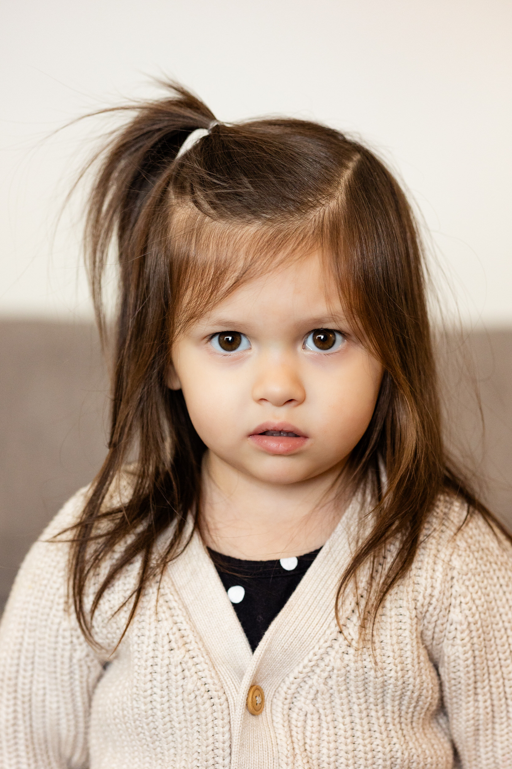 A young girl looks at the camera.