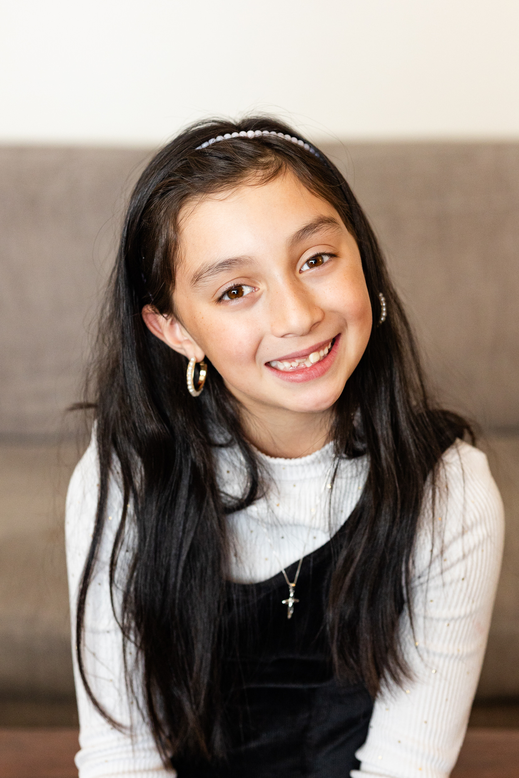 A young girl smiles at the camera.