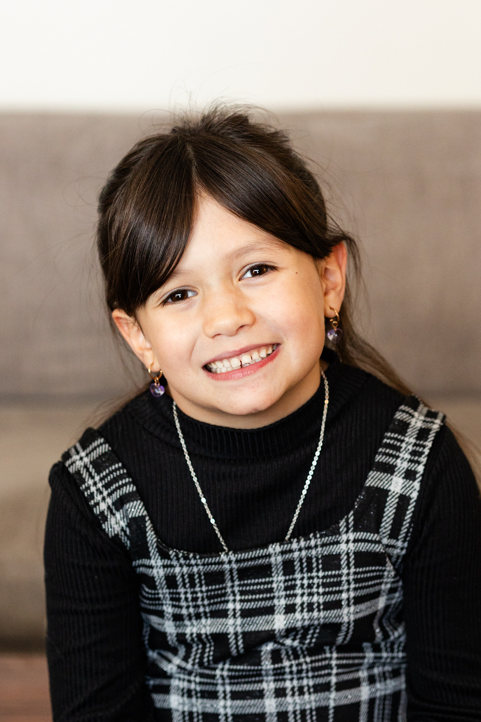 A young girl smiles at the camera.