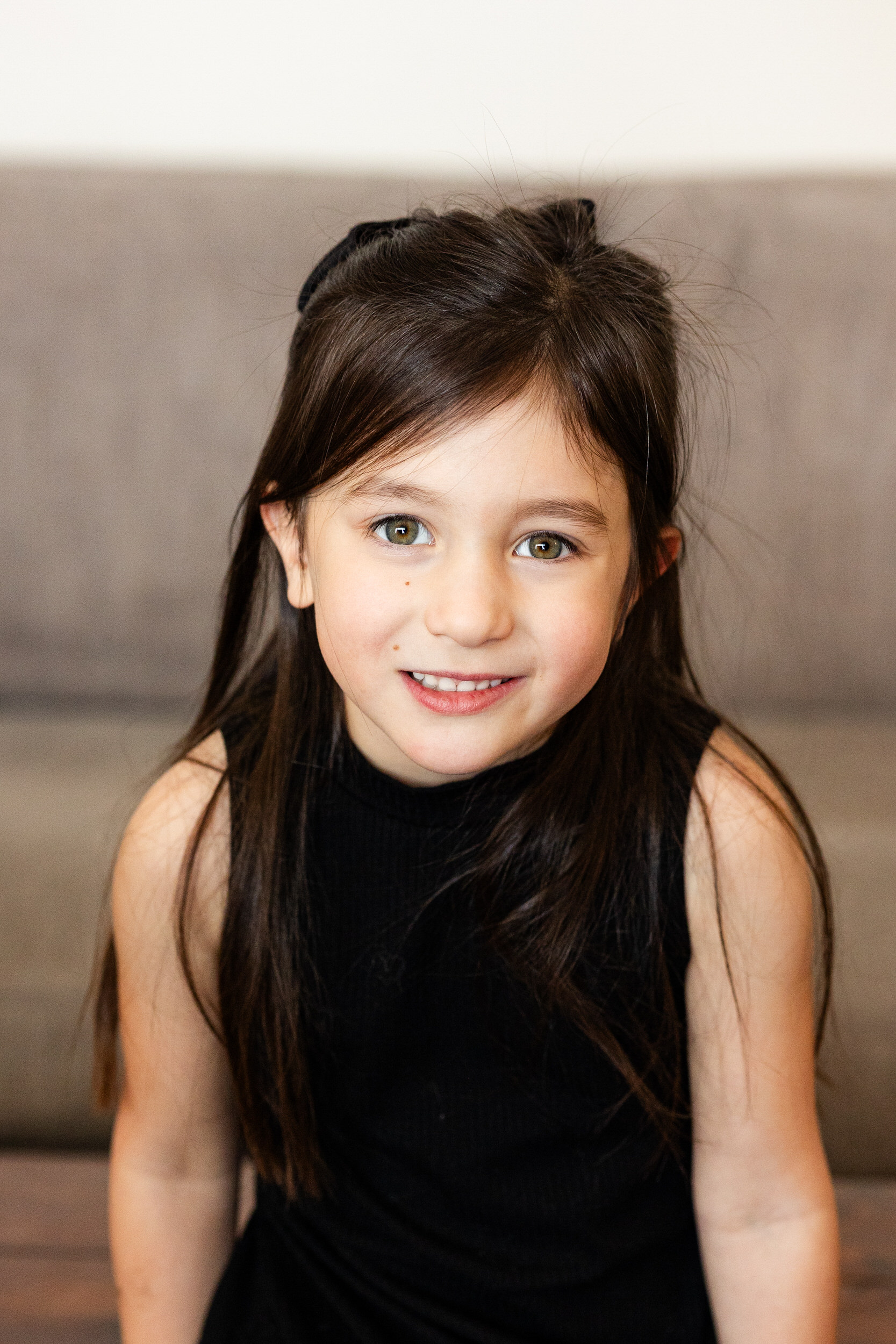 A young girl smiles at the camera.