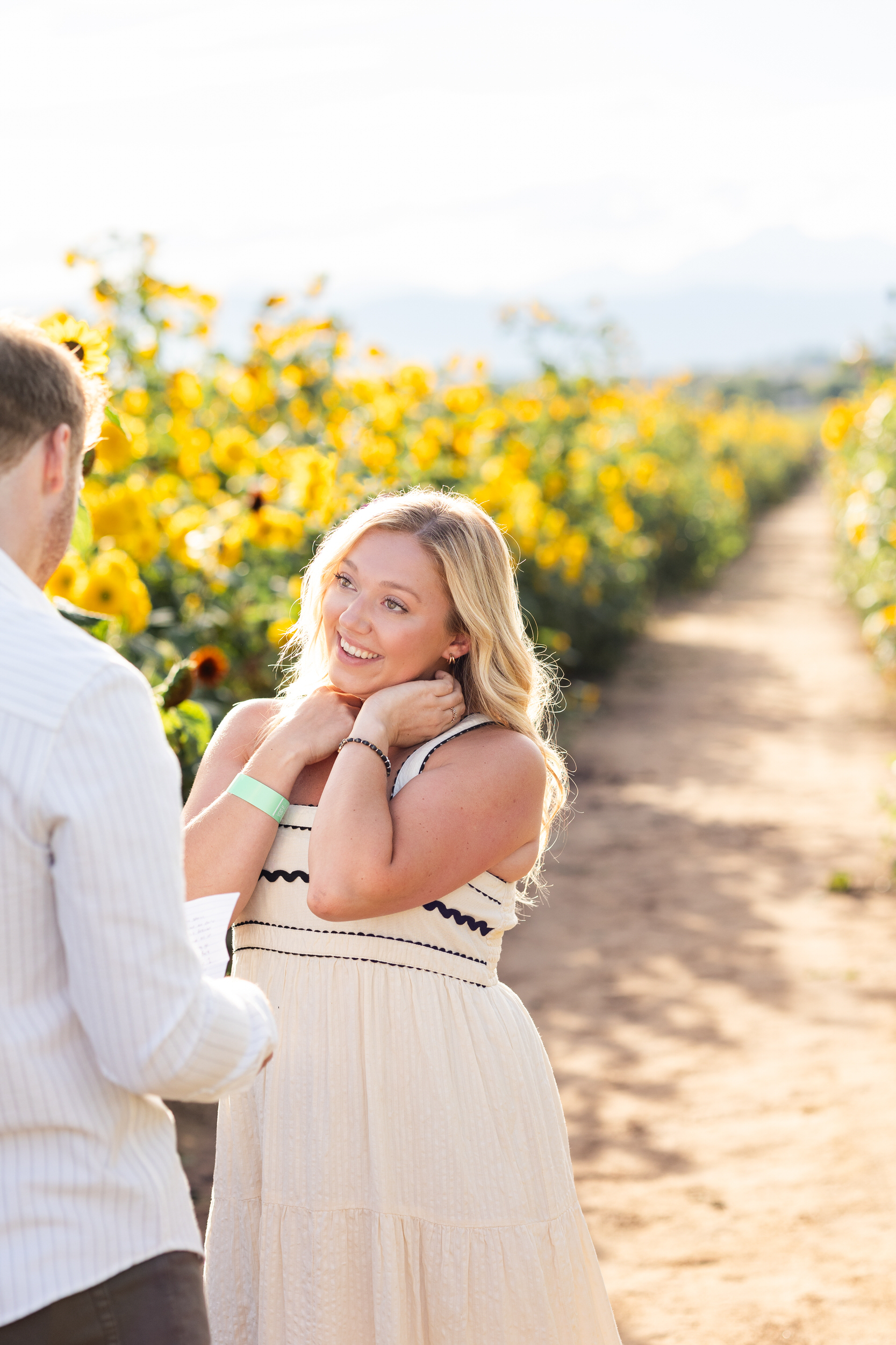 A woman smiles at her boyfriend as he begins his proposal.