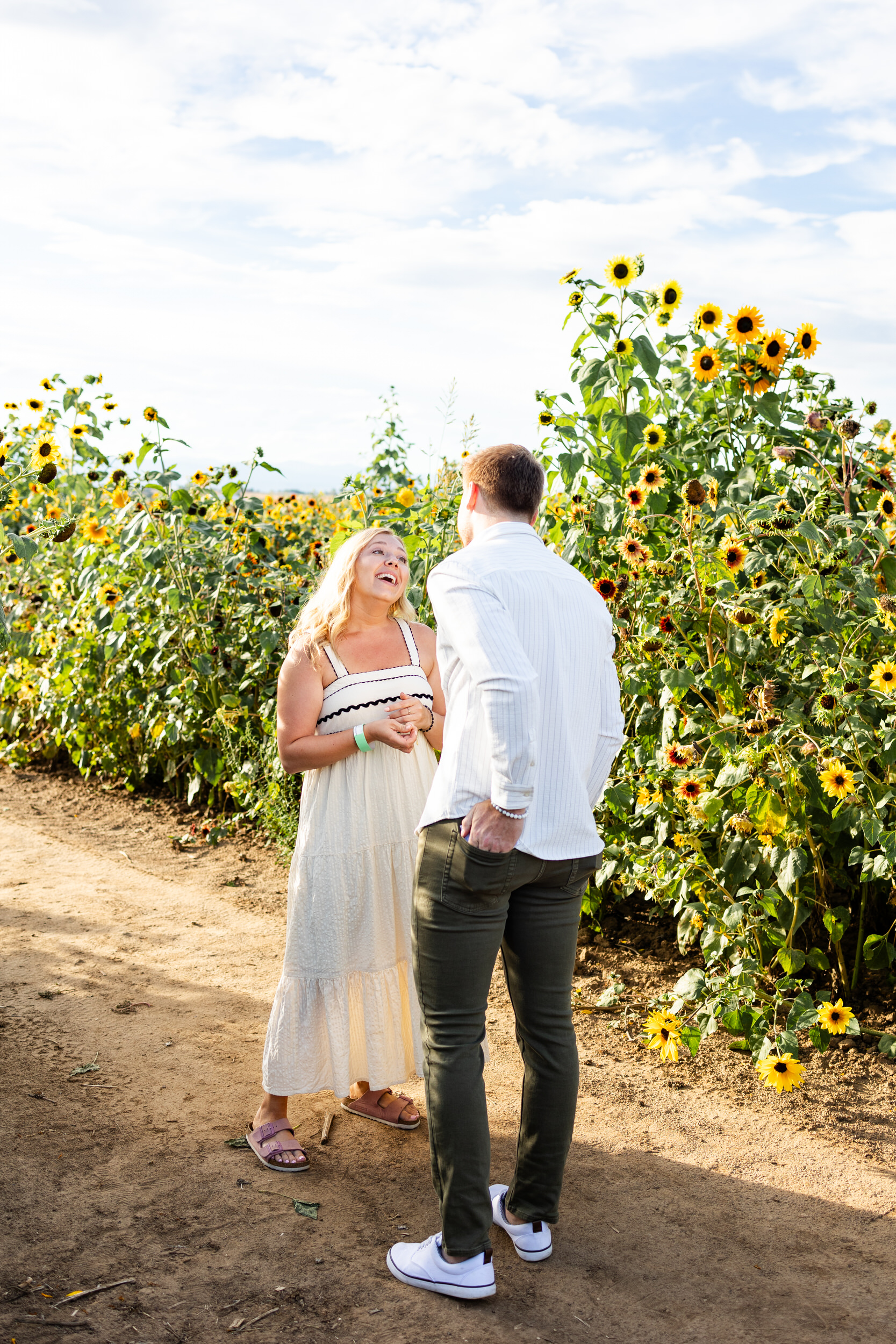 A man reaches for the engagement ring in his back pocket during the proposal.