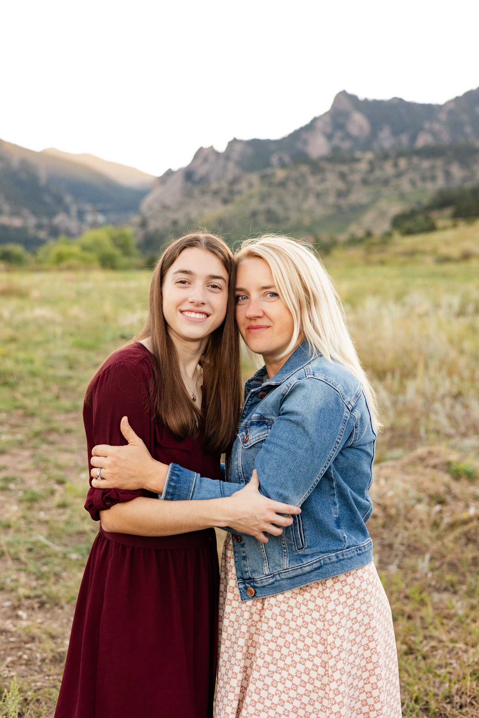 A young woman hugs her mom during her senior photoshoot.