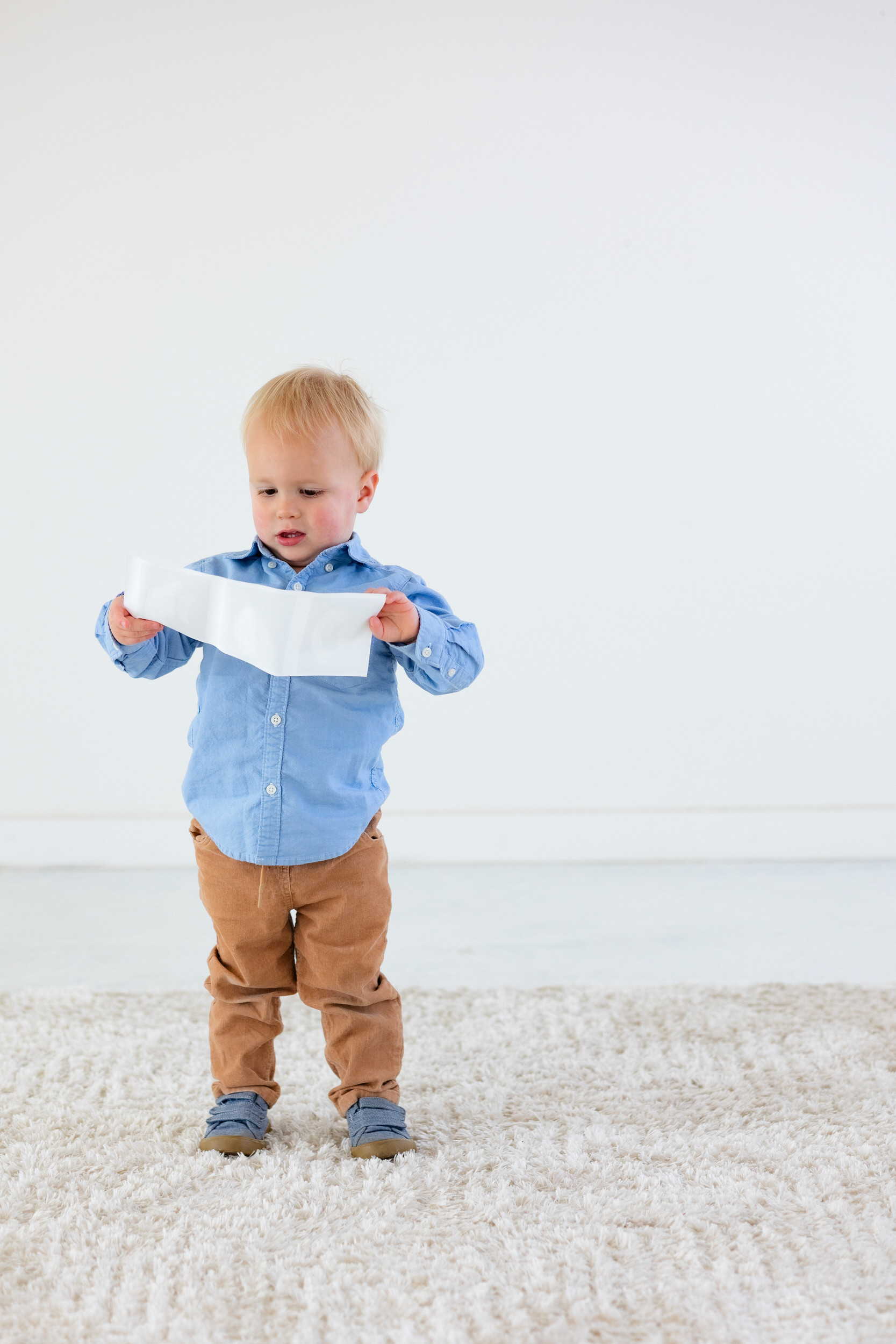 A two-year-old boy looks at ultrasound photos.
