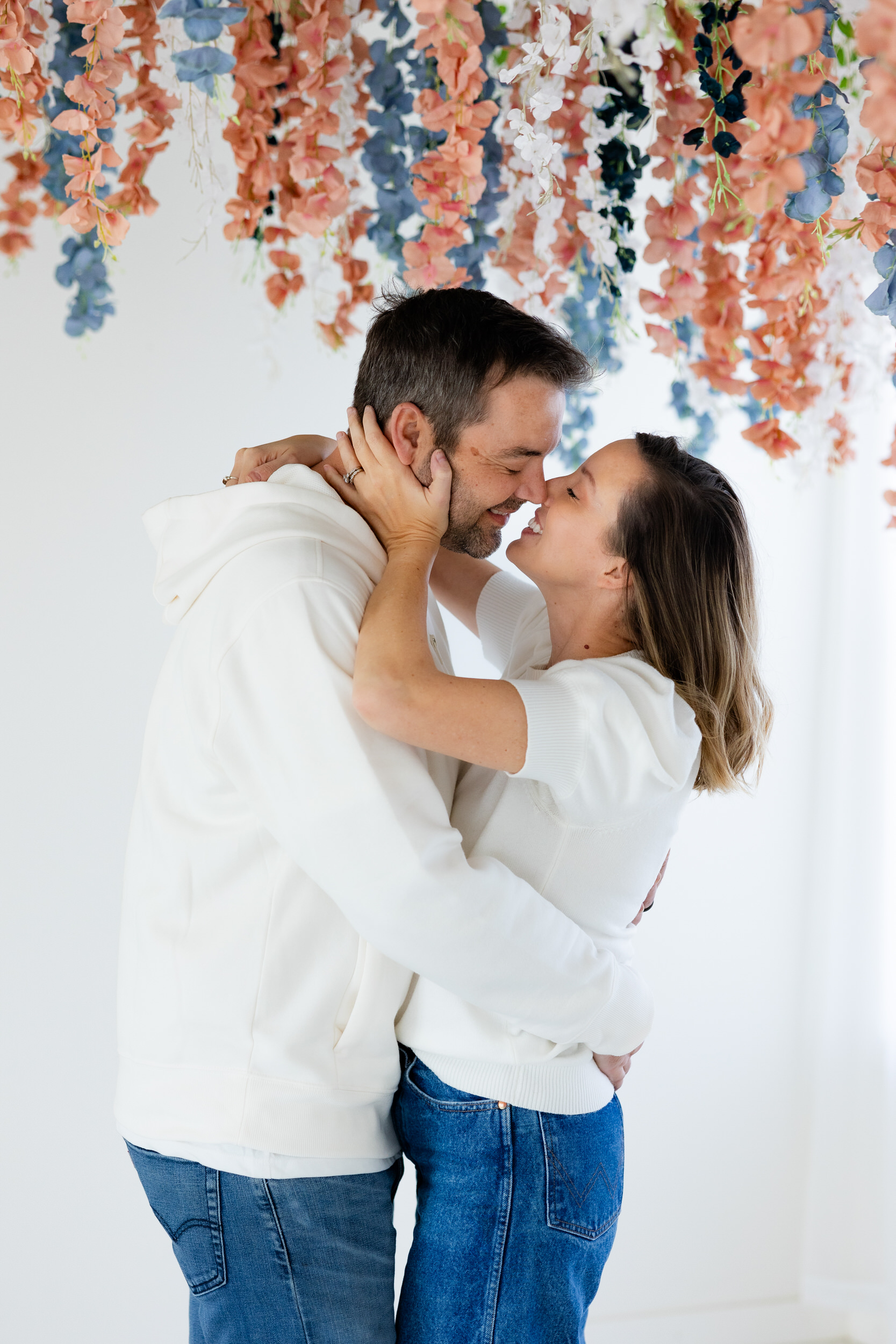 A husband and wife lean in for a kiss.