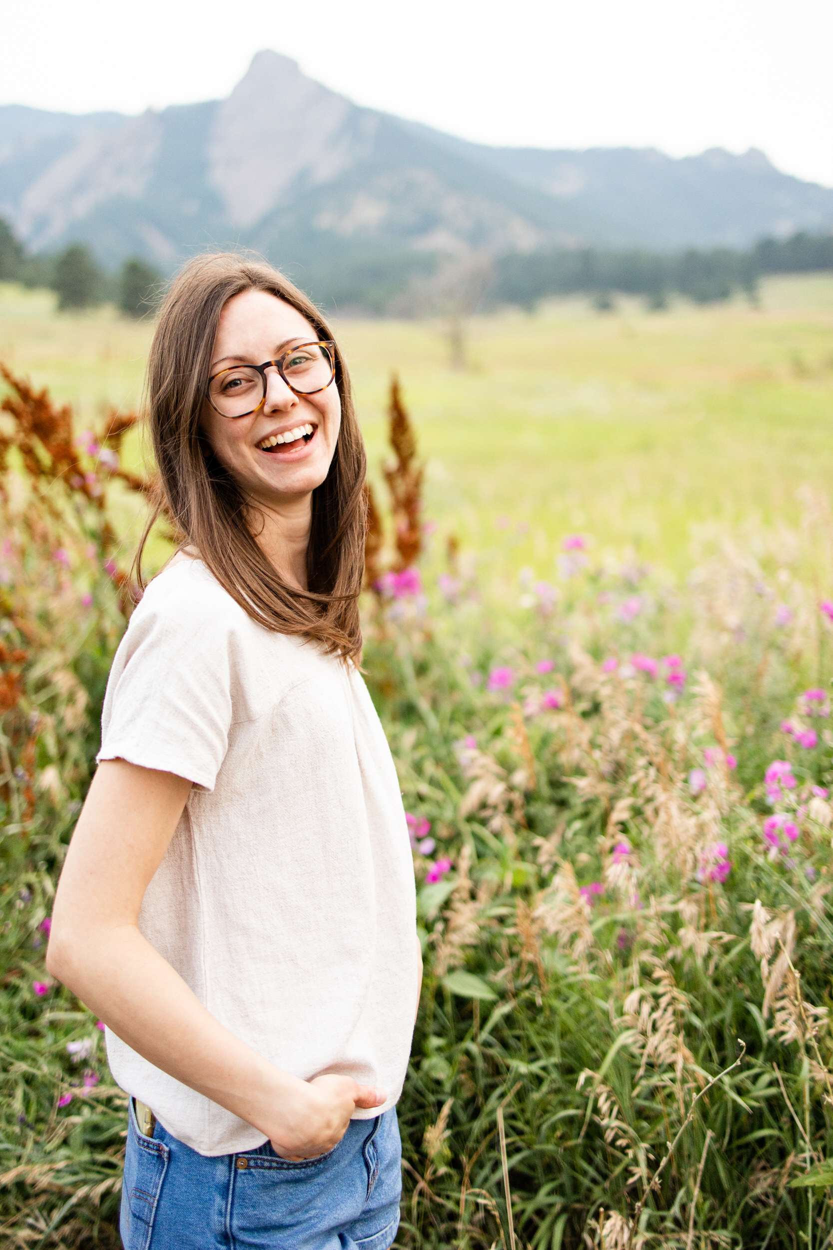 Young woman standing in a field of flowers.