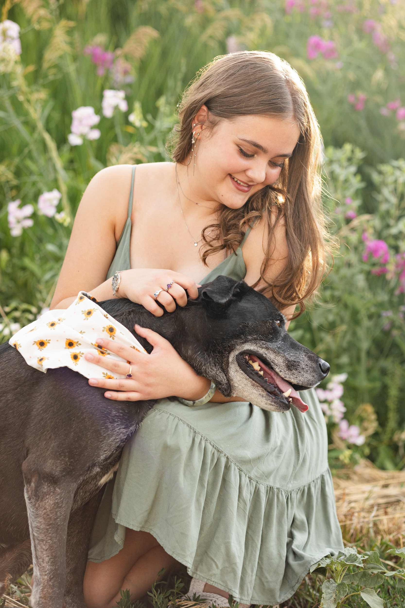 A woman hugs her dog.