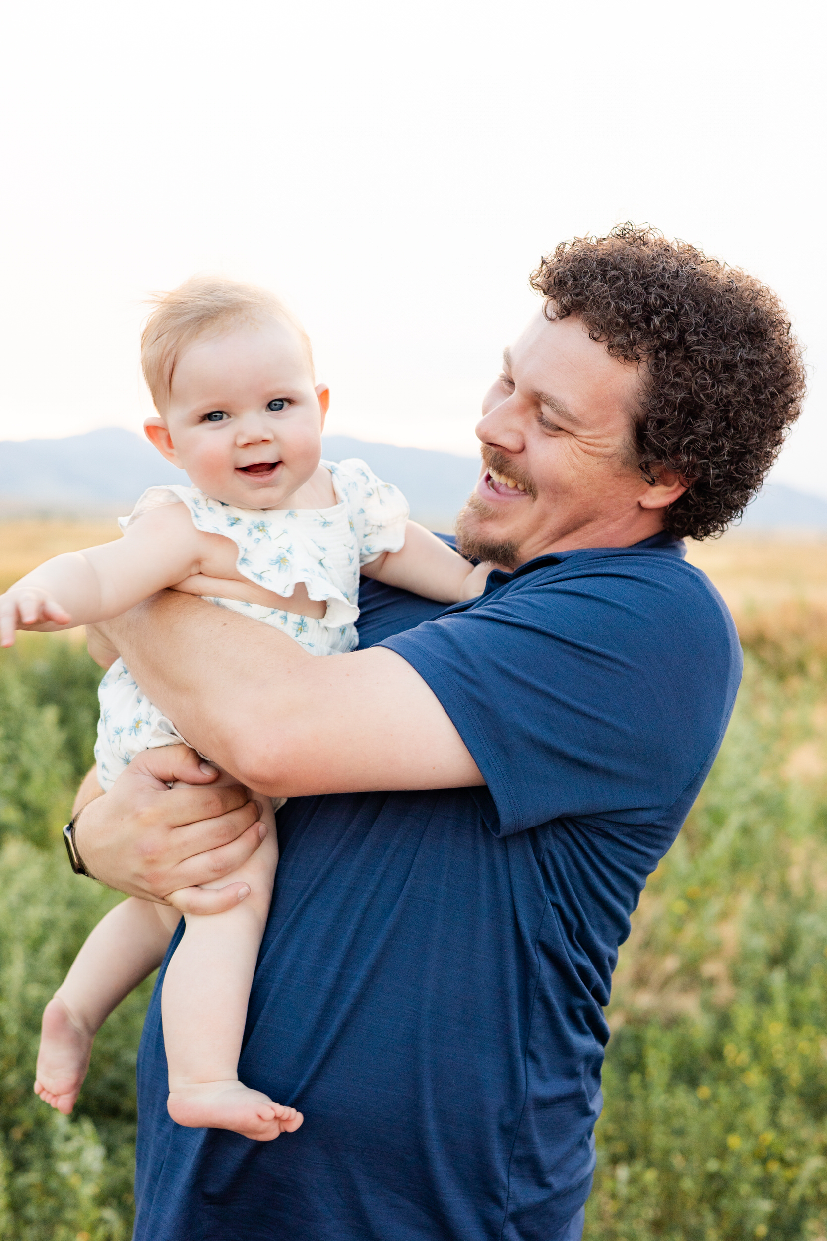 Dad smiles at baby girl.