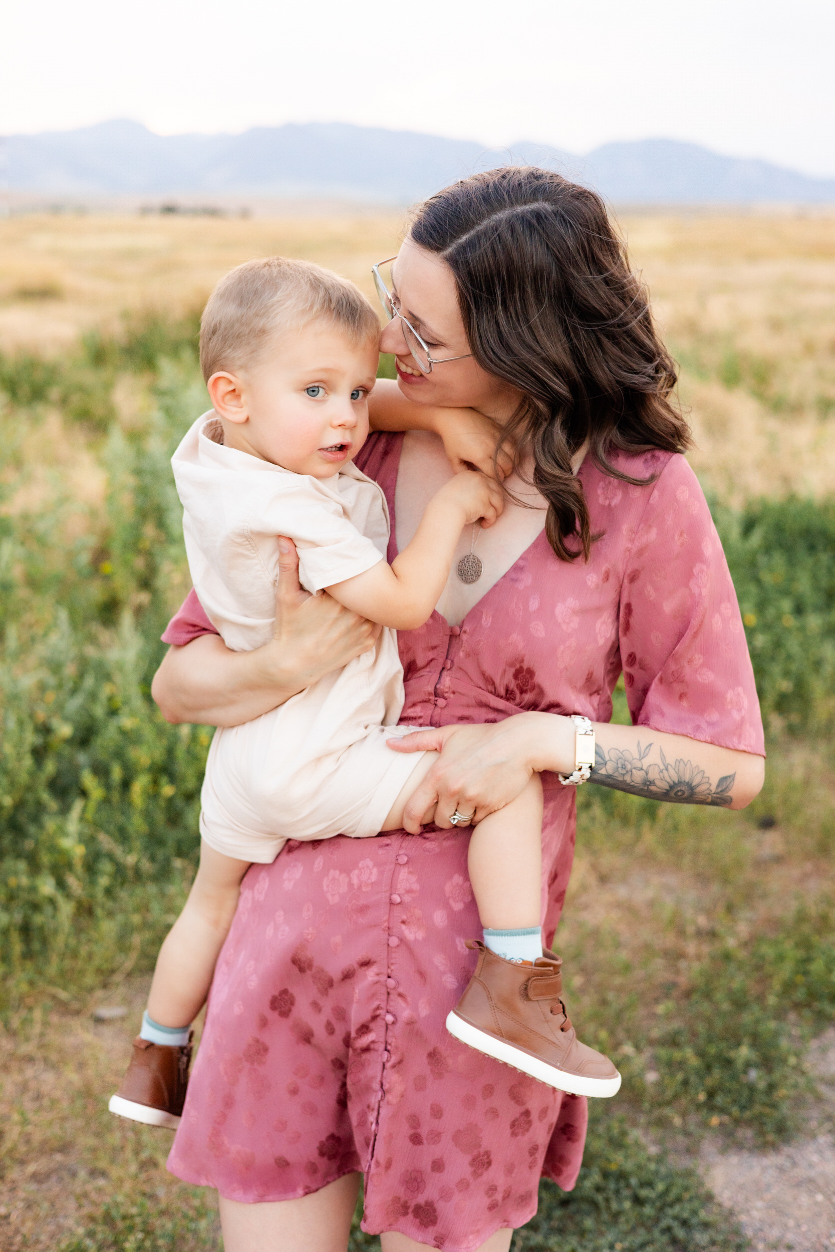 Mom snuggles young son.