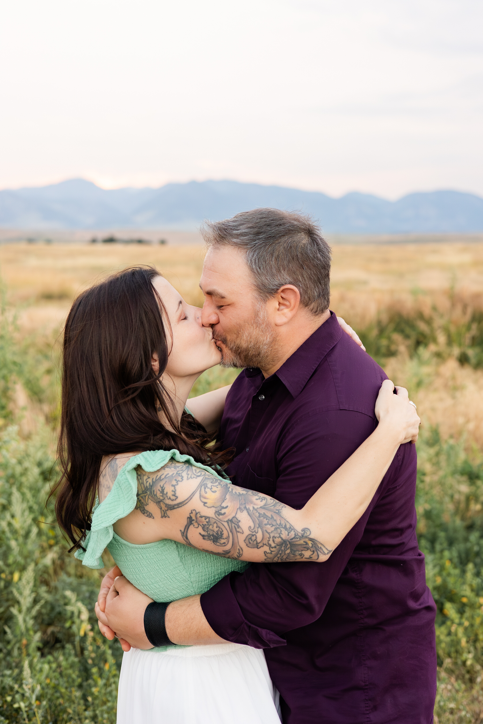 Husband and wife share a kiss.