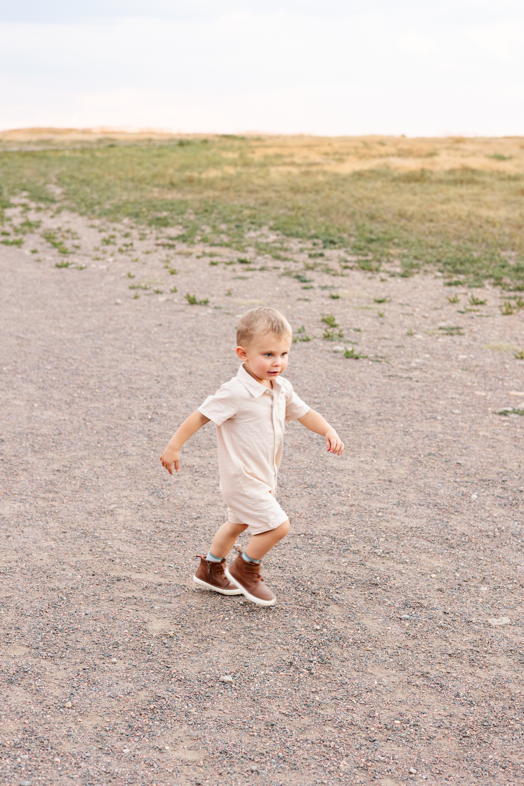 Toddler boy runs on a path