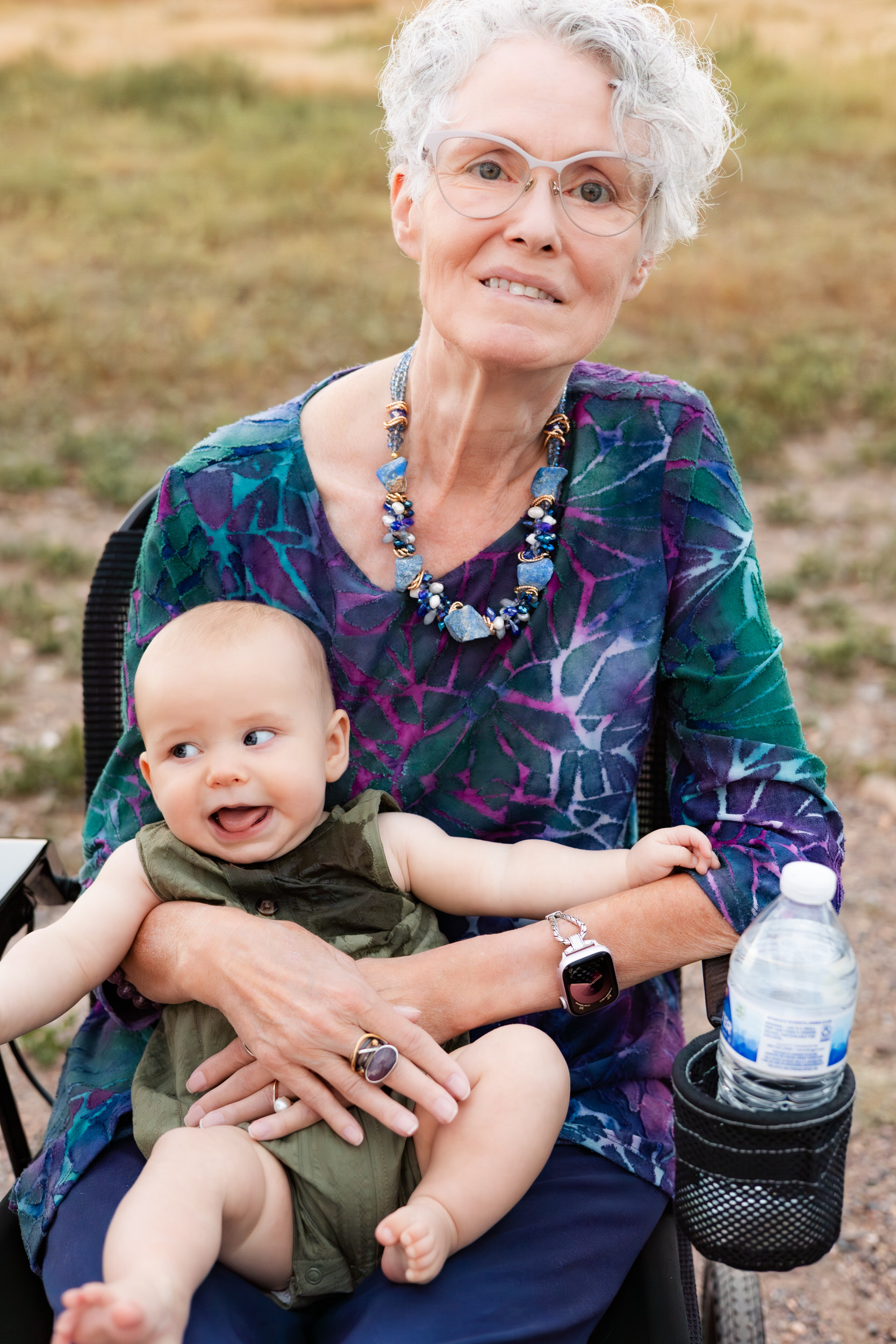 Grandma holds grandbaby in her lap