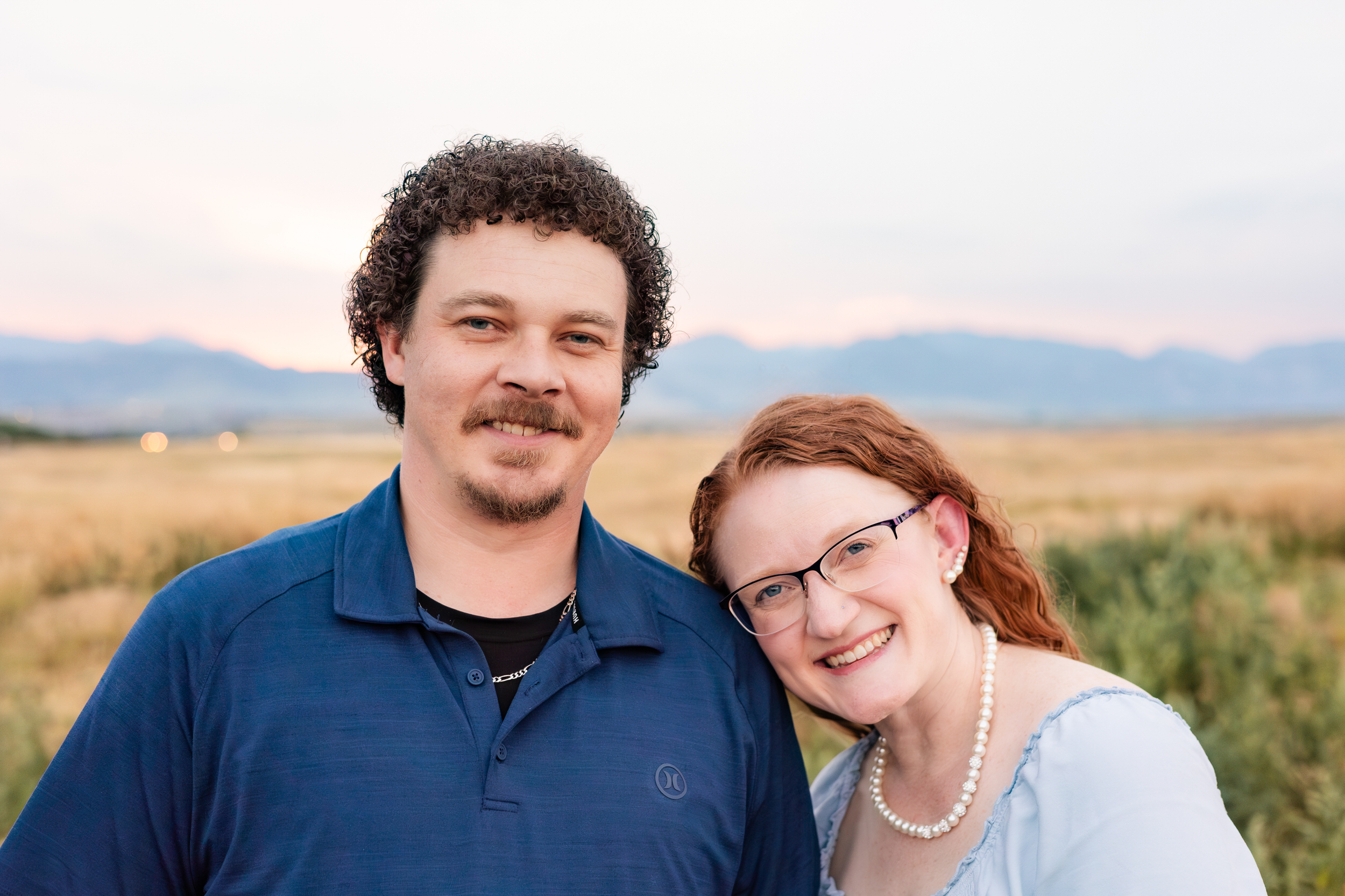 Husband and wife smile at the camera