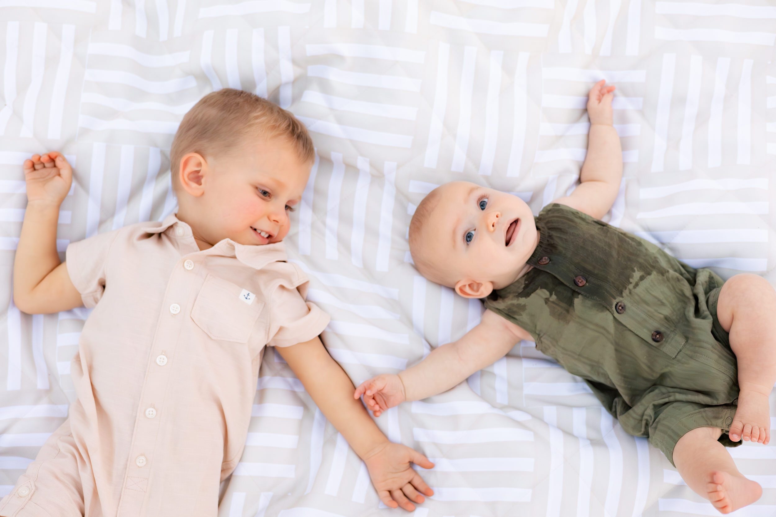 Young brothers lay on a picnic blanket together