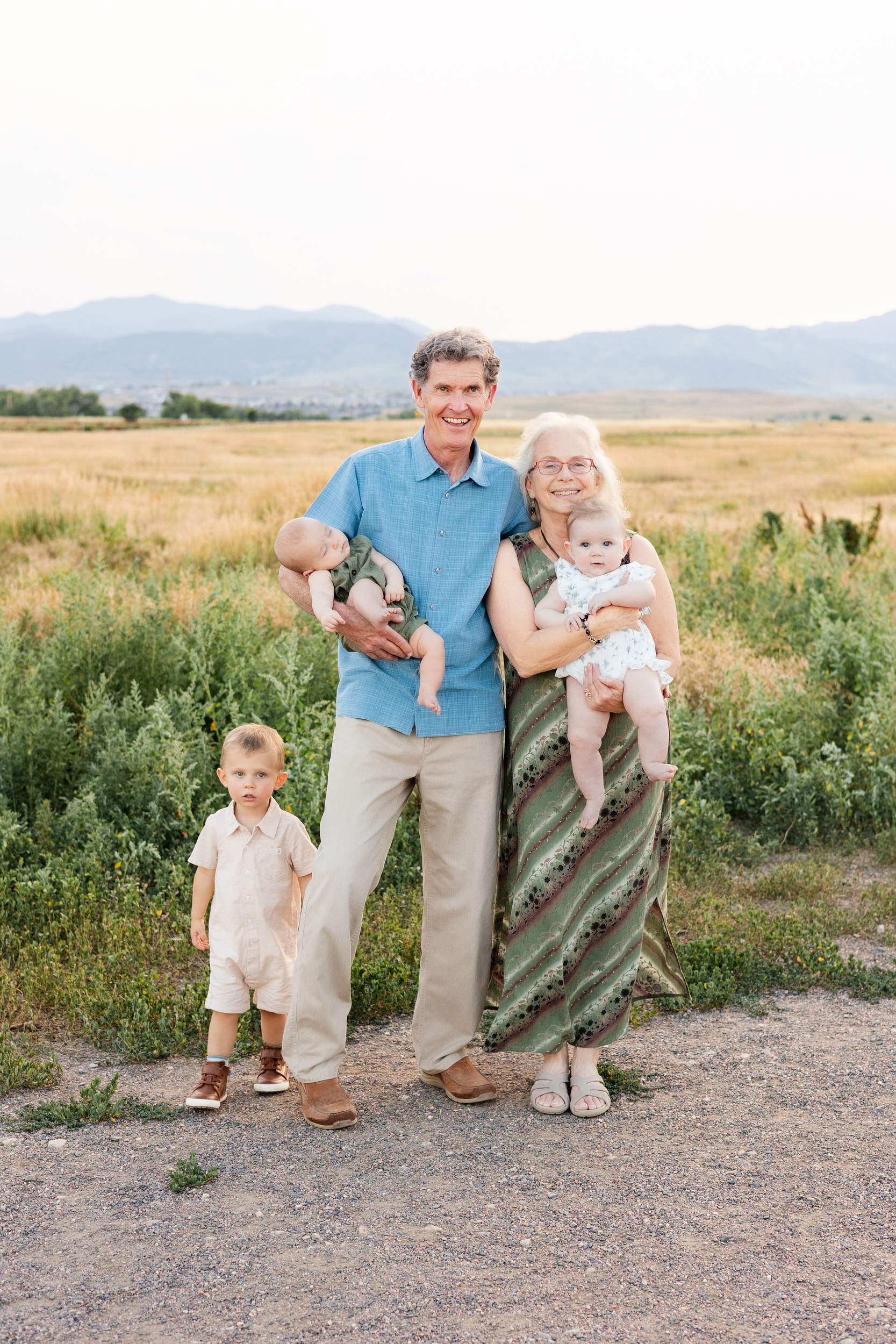 Grandma and grandpa smile with grandkids.