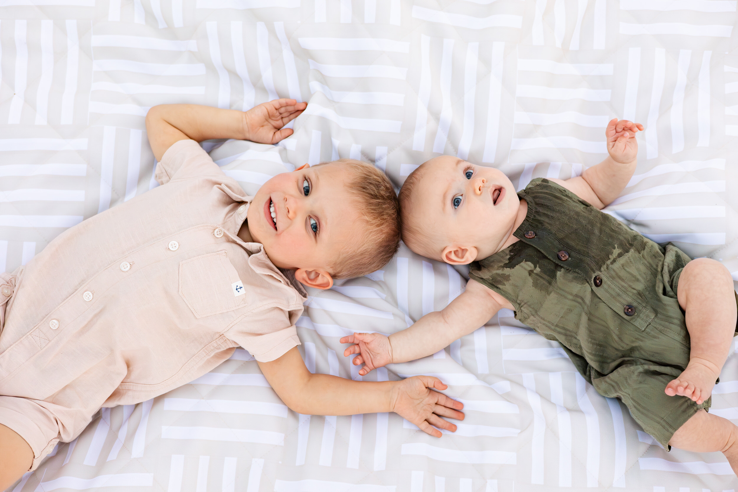 Young brothers lay on a picnic blanket together