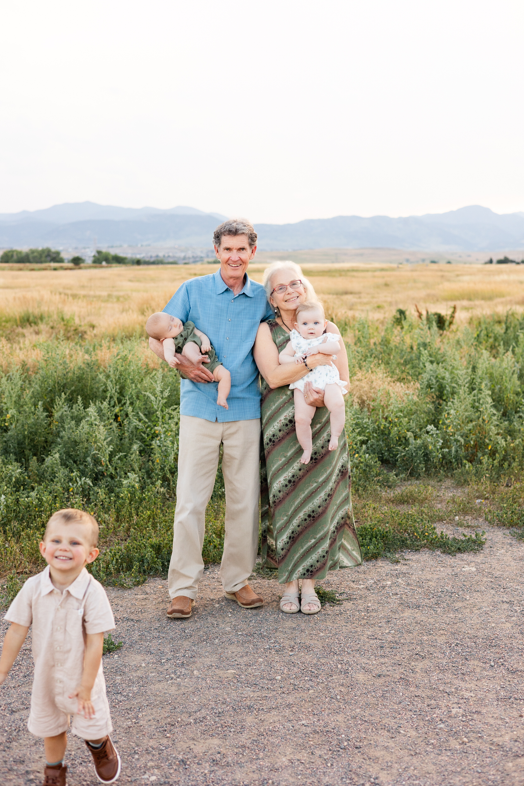 Grandma and grandpa smile with grandkids.