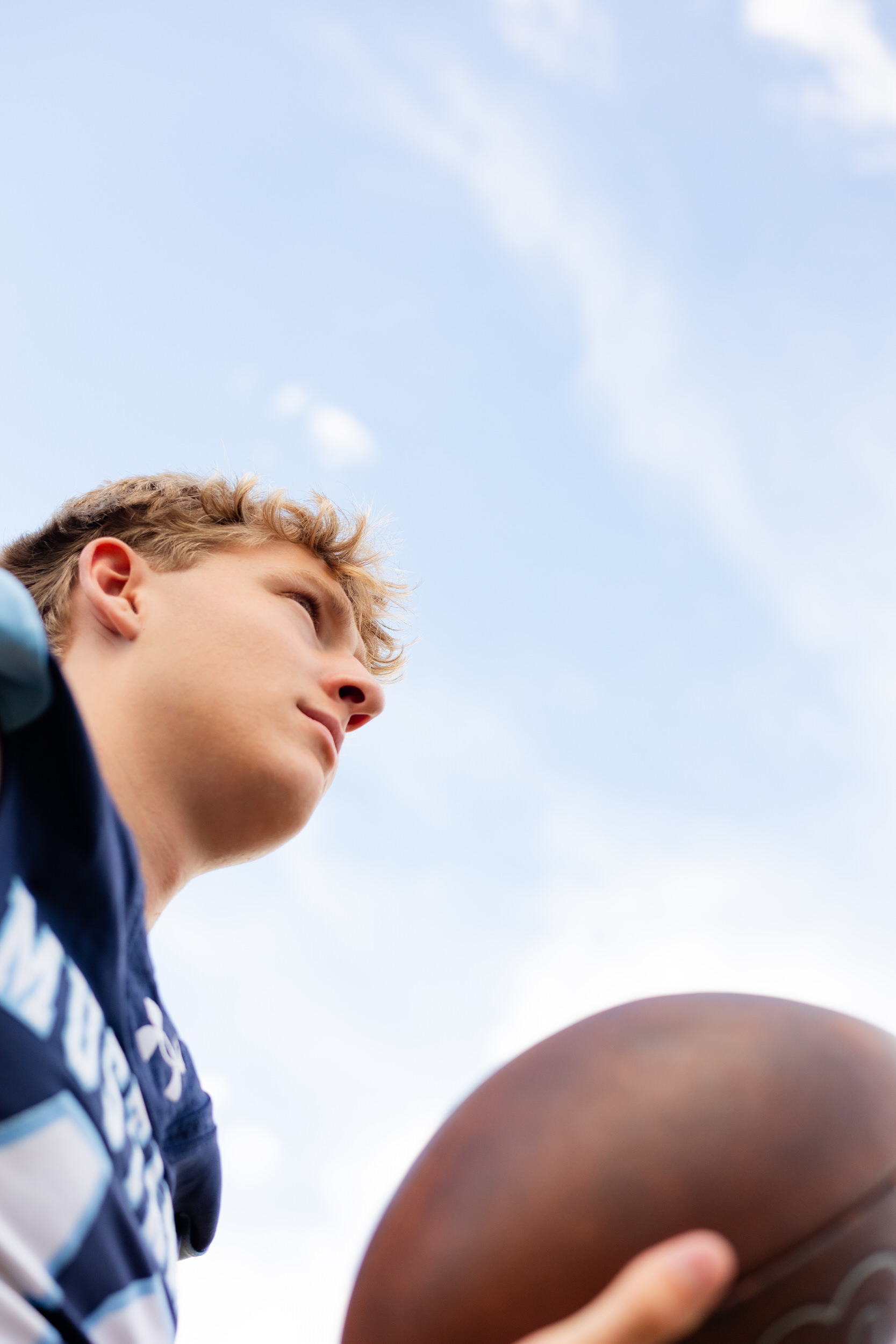 Young man catches a football.
