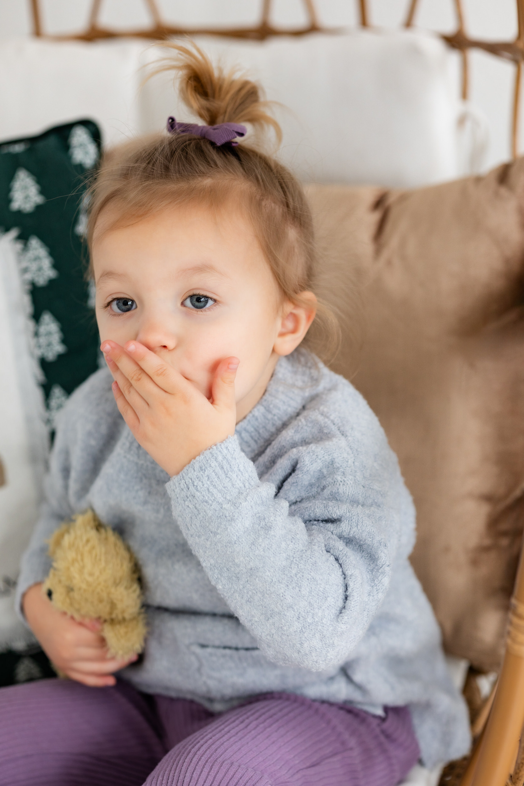Little girl touches her hand to her mouth right before she blows a kiss to the camera.