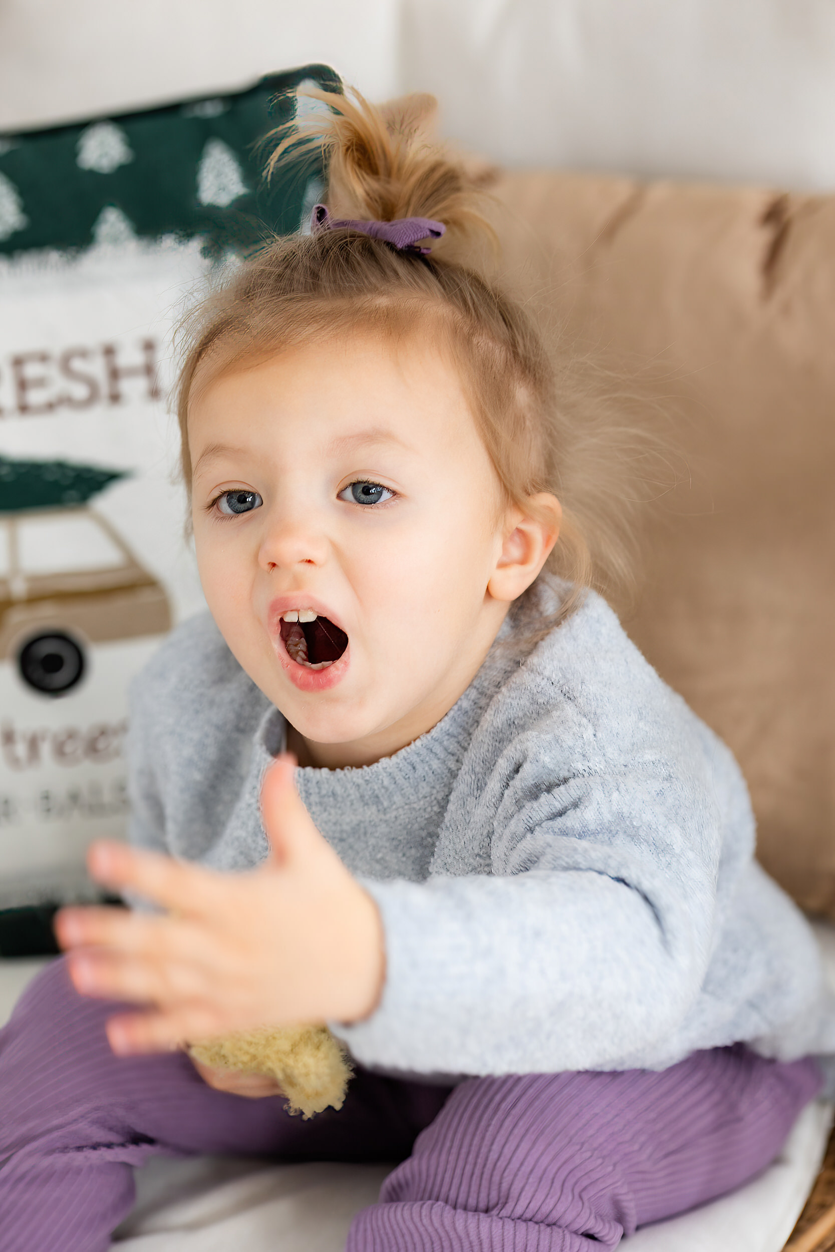 Little girl blows a kiss to the camera.