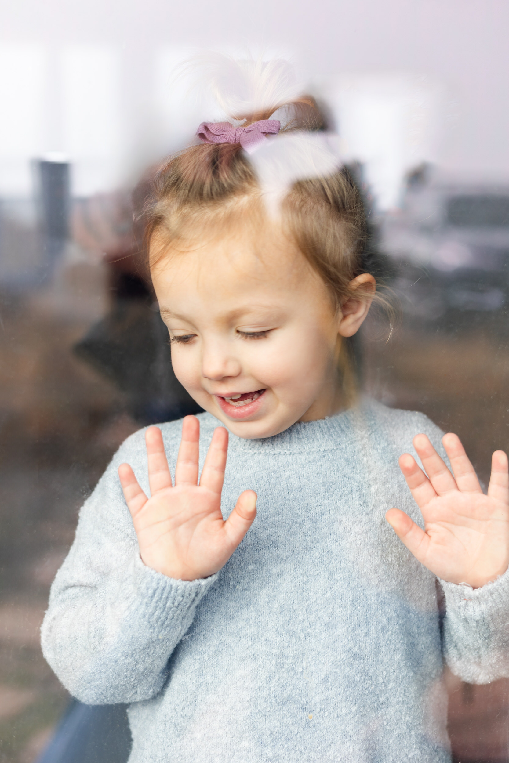 Little girl look outs window.