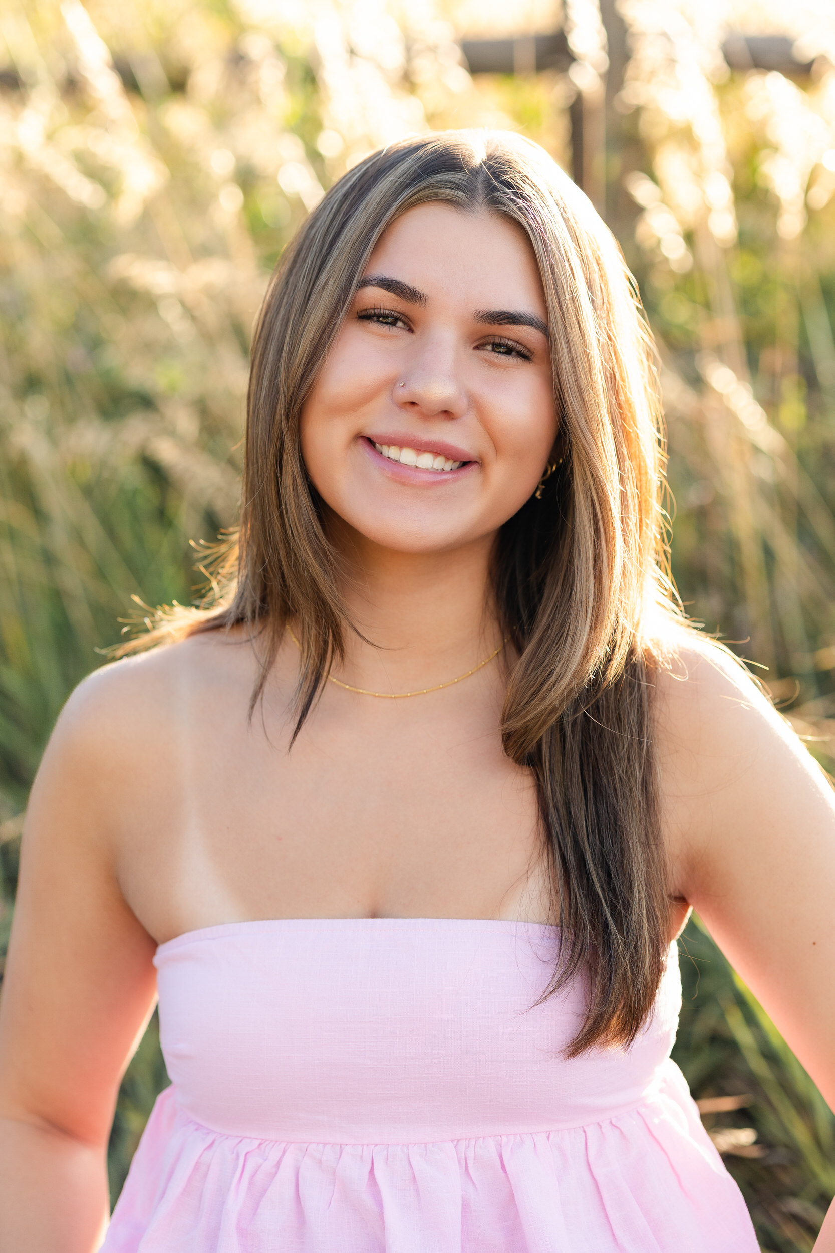 A young woman smiles at the camera.