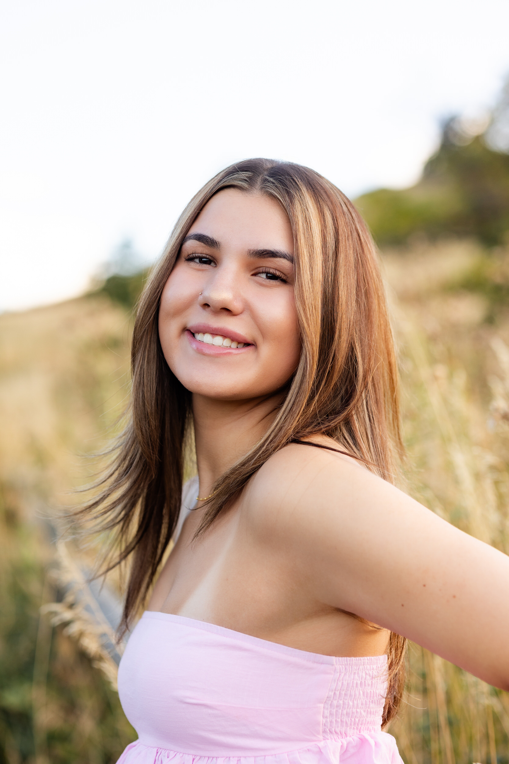 A young woman smiles at the camera.
