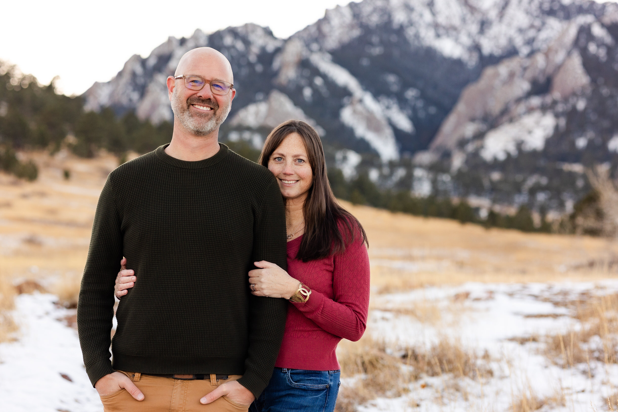 Husband and wife smile at the camera.