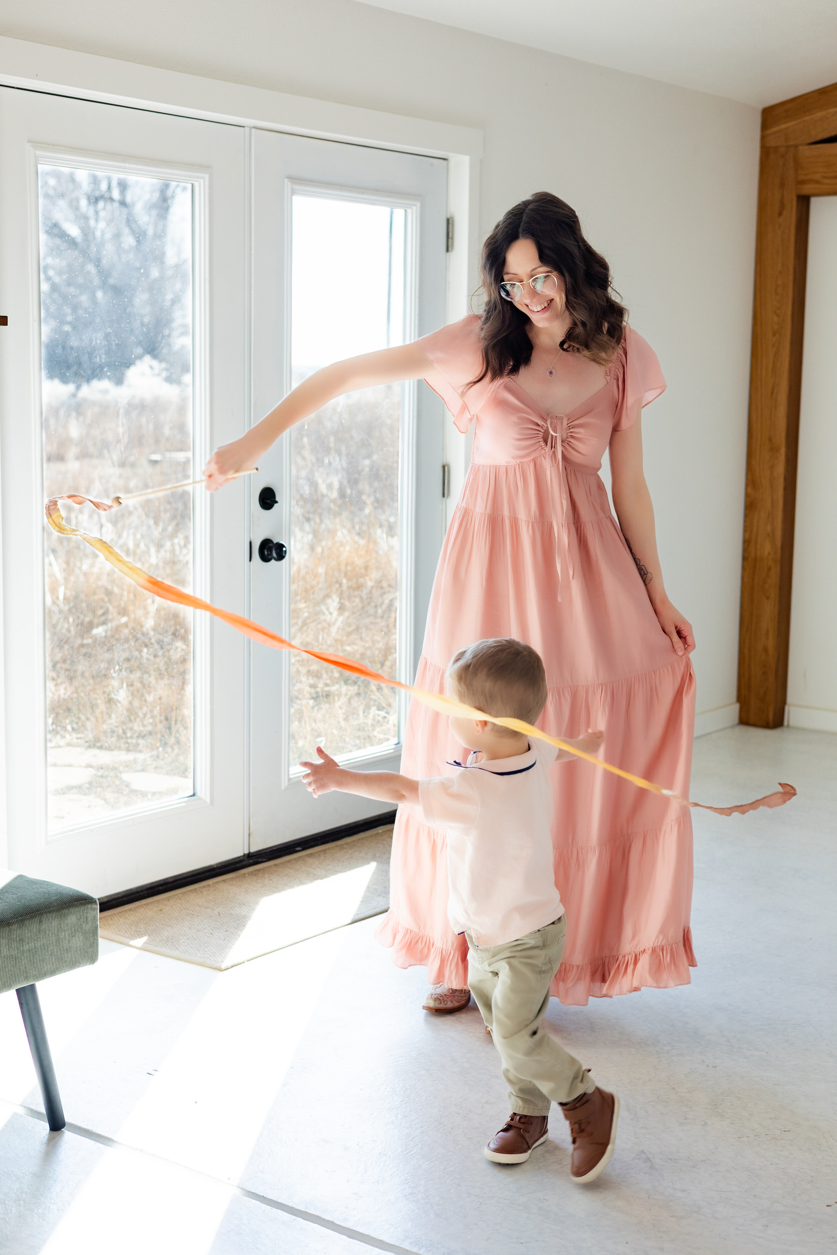 A mom and her young son play together with a play silk toy from Sarah's Silks.