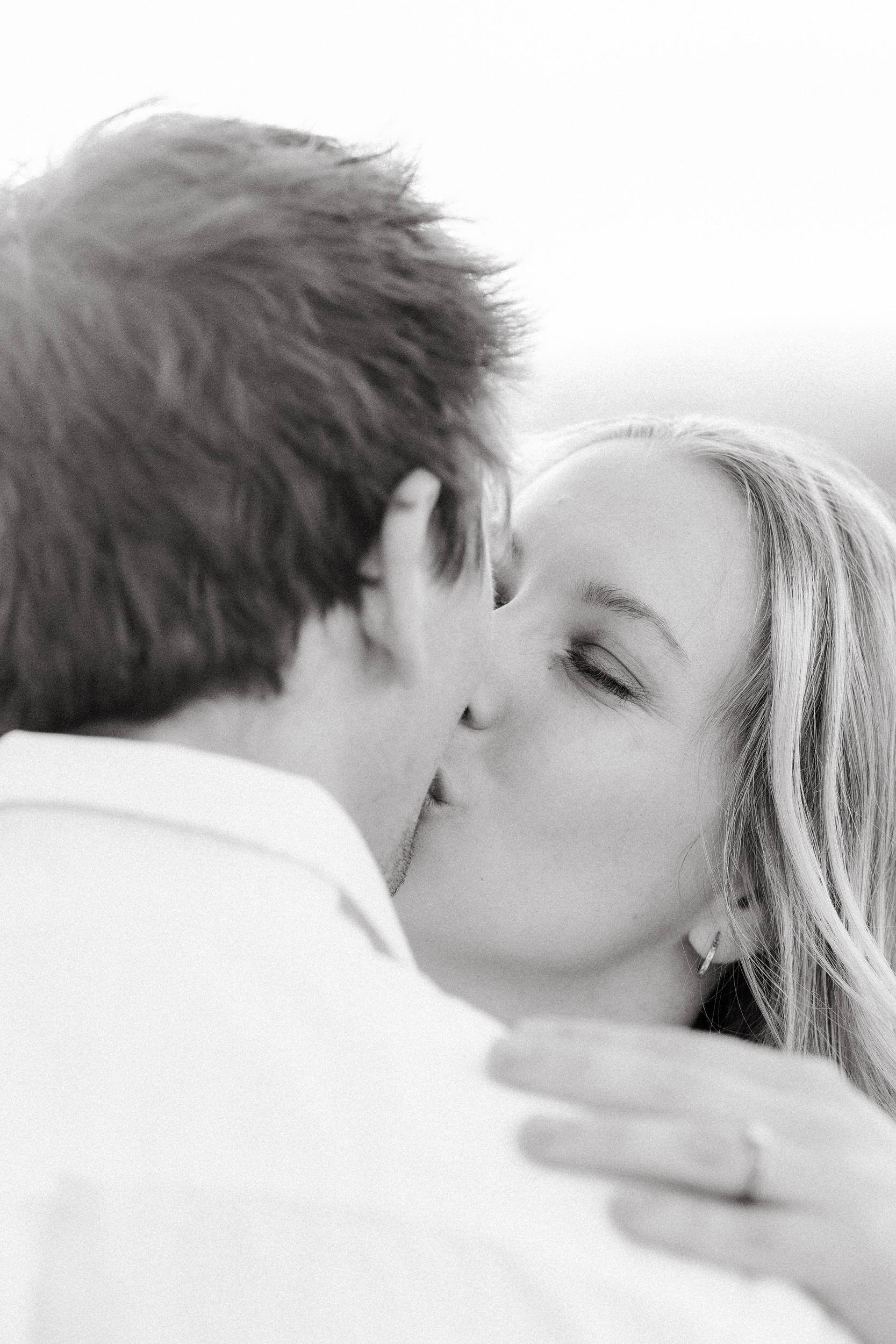 Husband and wife share a kiss furing their anniversary photoshoot.