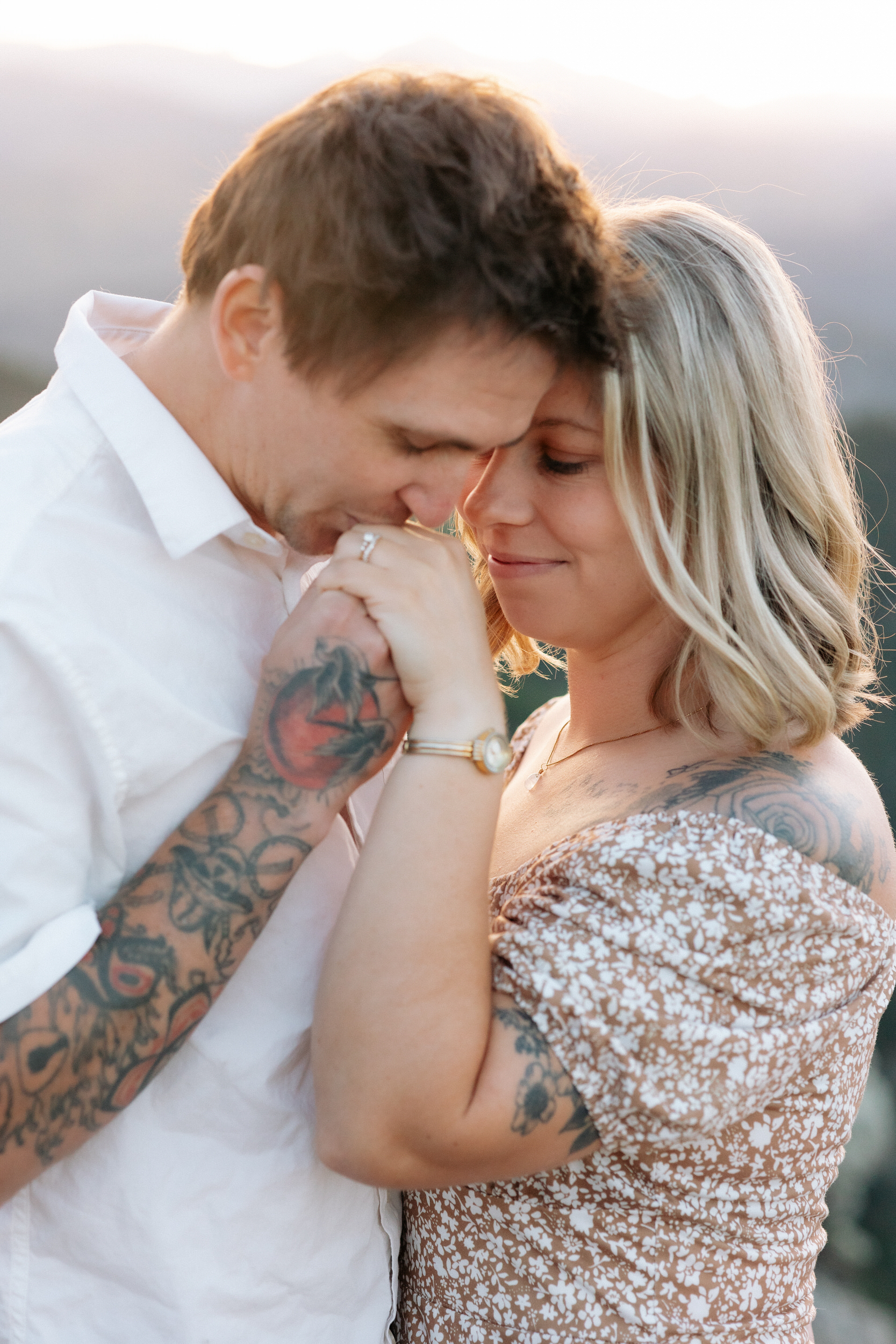 Husband kisses his wife's hand during their anniversary photoshoot in Boulder, Colorado.