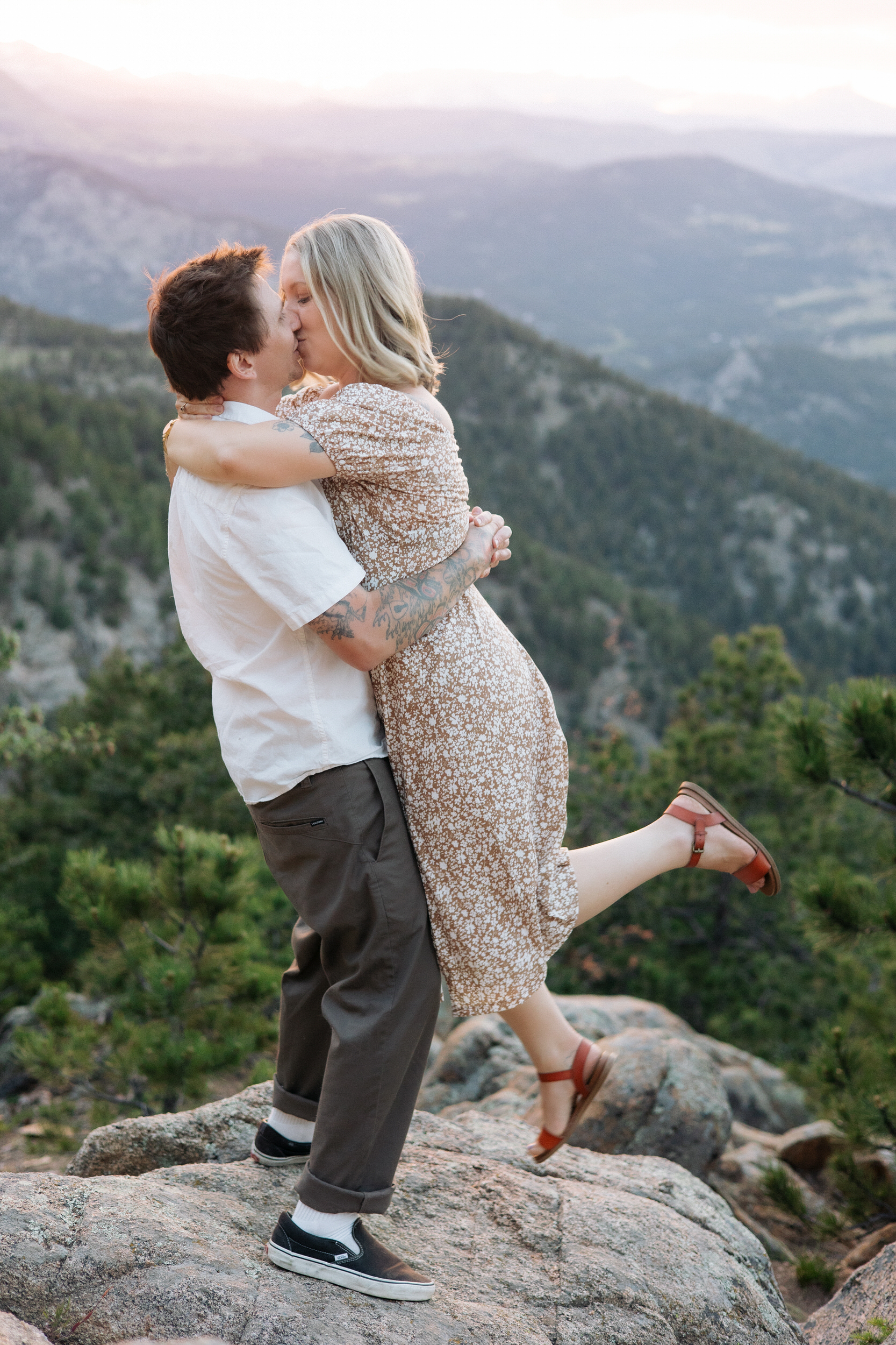 Husband kisses wife at Lost Gulch Overlook in Boulder, Colorado.